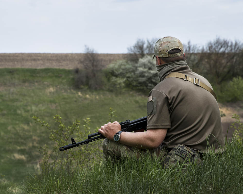 man with a gun sitting